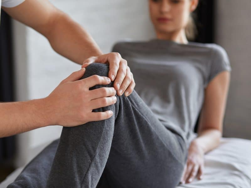 Female,Patient,Doing,Physical,Exercises,With,Physiotherapist.,Male,Therapist,Treating